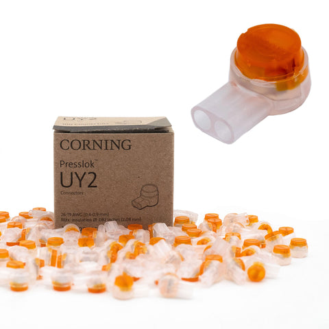 Corning UY2 Presslok wire splice connectors, transparent bodies with orange caps, boxed with loose connectors.