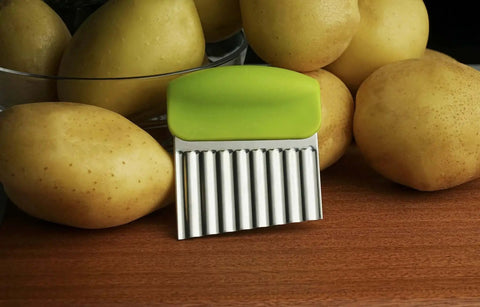Fun Crinkle Cutter Knife Set Two Pack For Potatoes Vegetables And Fruits, showing wavy slicer with green handle next to potatoes.