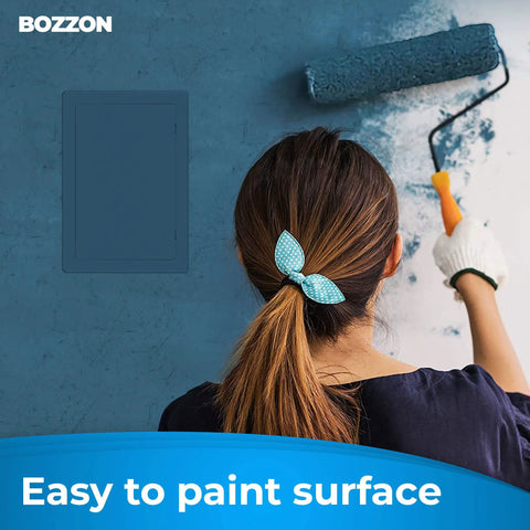 Drywall access panel, 6x9 in, insulated white plastic, mounted on blue wall while painter works