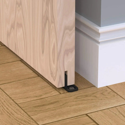 Sliding Barn Door Floor Guides Black 4 Pack Bottom Track Guides For All Sliding Doors Including Bypass And Pocket Doors Easy To Install Closet And Barn Style Durable Plastic Guides For Grooved And Non Grooved Tracks installed on wooden floor