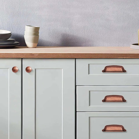 Antique Copper Cabinet Knobs 5 Pack One And A Quarter Inch Zinc Single Hole Center Pulls For Kitchen Cabinets And Drawers Vintage Retro Hardware Classic Rustic Cabinet Knobs For Home Renovation installed on light colored cabinets.