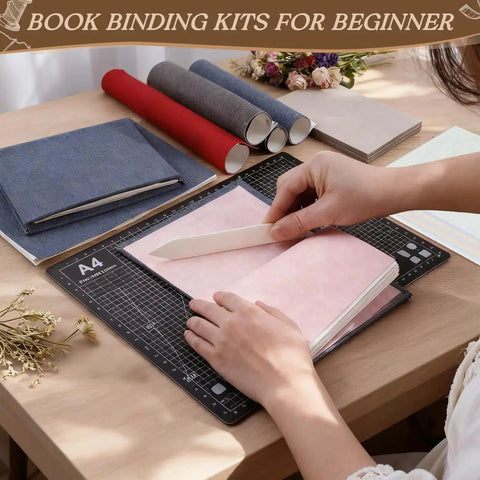 Person using bone folder on pink A5 paper from All In One 145Pcs Book Binding Kit For Beginners With A5 Paper And Tools