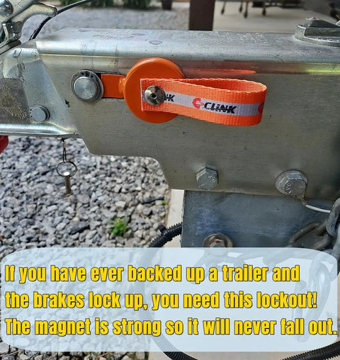 C-CLNK surge brake lockout key with magnet, orange strap on trailer hitch plate