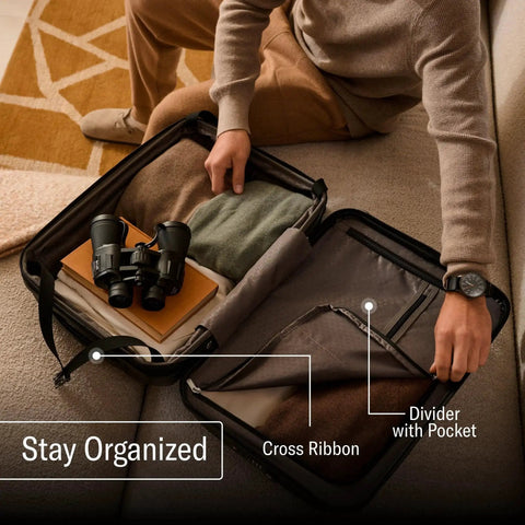 Person organizing clothes in Freeform Hardside Carry On Luggage With Spinner Wheels By Samsonite, showing spacious interior.