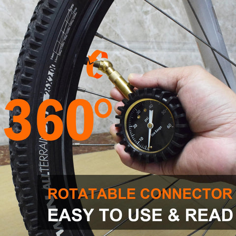 Tire pressure gauge with a 2-inch glowing dial and brass connector held against a bicycle tire valve