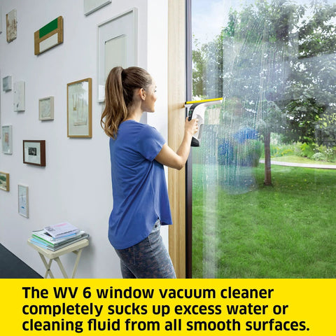 Kärcher WV 6 electric window vacuum squeegee on a glass window; white body with yellow top.