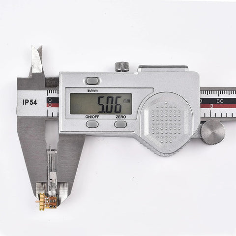 Planetary gearhead motor module held in a digital caliper showing 5.06 mm, silver metal