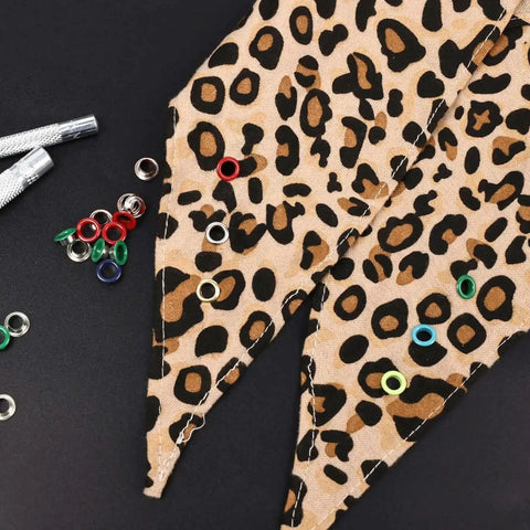 Colorful Grommet And Eyelet Kit with 680 pieces in 17 colors on leopard print fabric for DIY projects