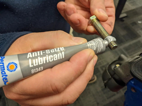 Applying Marine Grade Anti Seize Lubricant 1 Oz Tube With Aluminum Copper Graphite Blend to a bolt thread