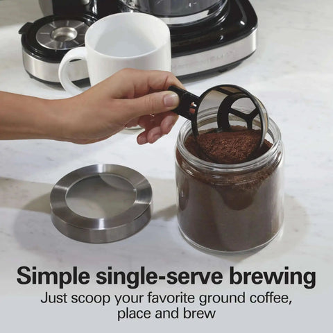 Hand scooping coffee grounds for 2 Way Programmable Coffee Maker With Single Serve And 12 Cup Glass Carafe Black With Stainless Steel Accents