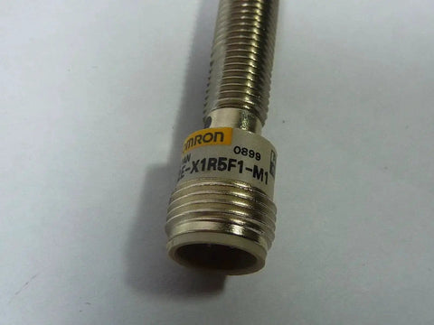 Inductive Proximity Sensor With 1.5 Millimeter Sensing Range PNP Output And 10 To 40 V DC Supply Cylindrical Housing RoHS Compliant Model E2E X1R5F1 M1 Proximity Sensor For Industrial Automation showing cylindrical metal body.