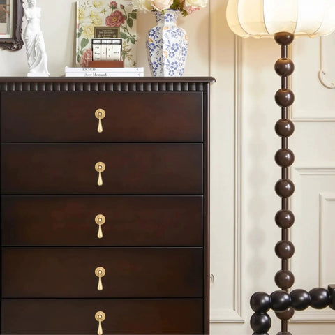 Dark wood dresser with Solid Brass Cabinet Knobs 2 Pack in Brushed Gold Finish installed, showing modern pendant pulls for cabinets and drawers.