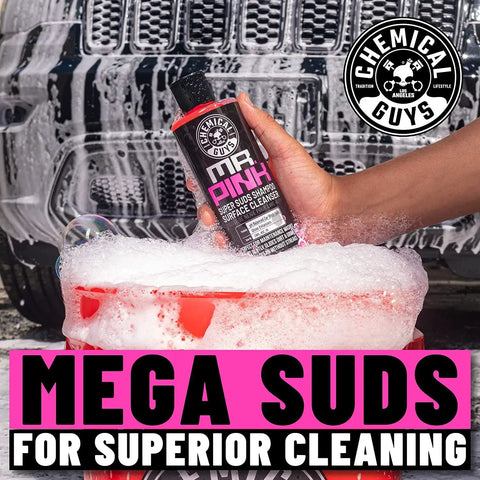 Mr Pink Foaming Car Wash Soap For Foam Cannons And Buckets Candy Scent Safe For Cars Trucks Motorcycles RVs And More 473 Ml Chemical Guys in hand above a bucket filled with foam.