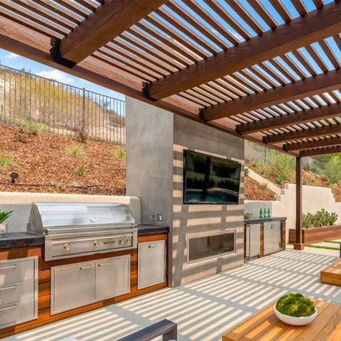Outdoor patio with wooden pergola, stainless steel grill and TV. Part of a home construction project using 24 Pcs 2x4 Joist Hangers Set Q235B Steel.