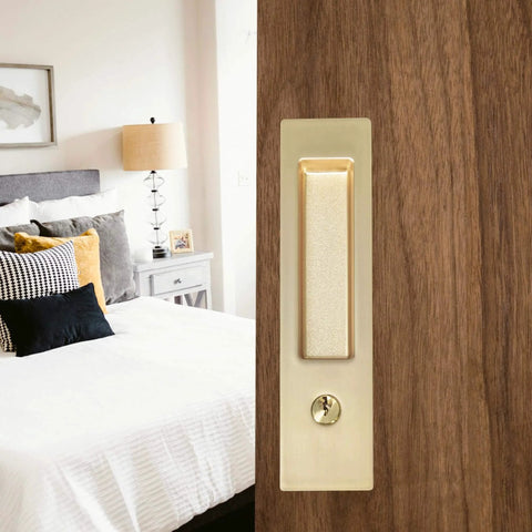 Privacy Pocket Door Lock With Key And Handle, 7 Inch Brushed Gold Invisible Rectangular Edge Pull, shown installed on bedroom door.