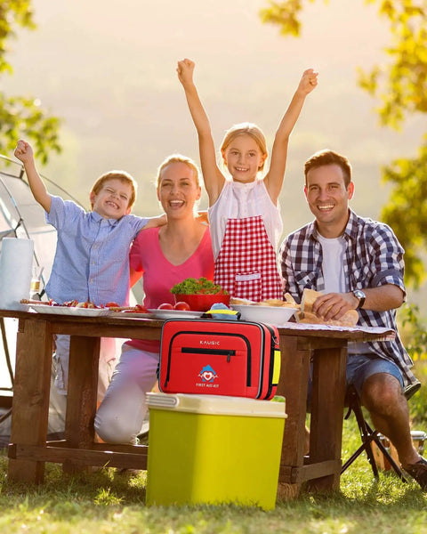 Family enjoying picnic with 500 Piece First Aid Kit For Car Home Travel Camping Dorms Waterproof Trauma Medical Kit on table
