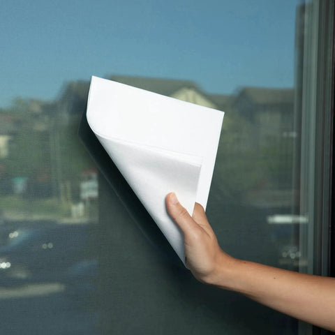 Hand using Miracle Cleaning Cloths 4 Pack Just Water Streak Free Reusable 16x16 on a glass window