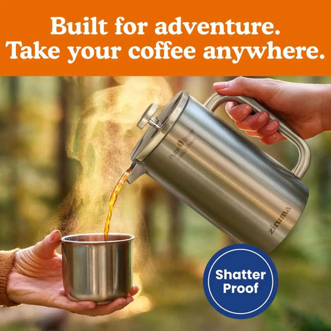 Person pouring coffee from Non-Toxic French Press Coffee Maker With Surgical Grade 316 Stainless Steel into a metal cup outdoors.