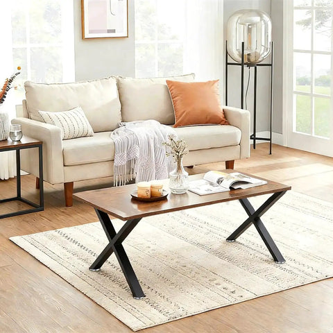 Living room with a wooden coffee table with Beefy Heavy Duty Black X Shape Coffee Table Legs 16H X 11.7W next to a cream sofa.