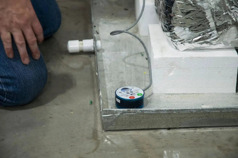 Wet Switch Flood Detector With Hydrophilic Pad And Integrated Feet near HVAC system on concrete floor