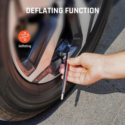 Person using Easy Read Pencil Tire Pressure Gauge Set For Cars Trucks RVs And Bikes By ETENWOLF to deflate tire, showing stainless steel body.