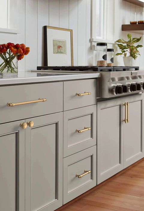 Champagne Bronze Traditional Cabinet Pull For Cabinets And Furniture Five And One Sixteenth Inch Center To Center Mounting Six And One Half Inch Overall Length Durable Drawer Handle One Pack Classic Hardware For Kitchen Or Bath installed on gray kitchen cabinets.