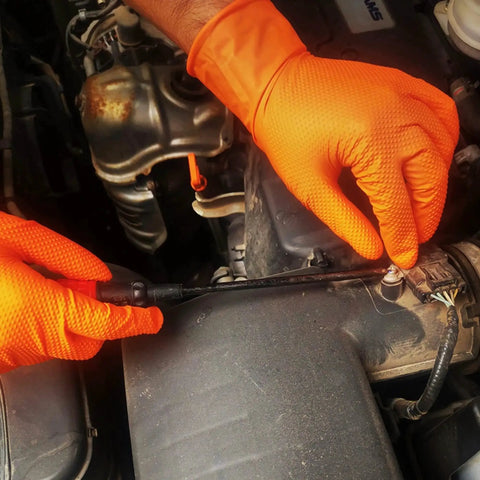 Mechanic wearing Heavy Duty Orange Nitrile Gloves 8 Mil Powder Free Diamond Grip 1000 Count, working on engine.