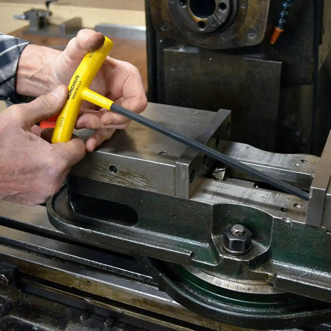 Using Set Of 10 Balldriver And Hex T Handles With Stand For 3/32 To 3/8 Inch in a machine shop setting, highlighting ergonomic grip and steel build