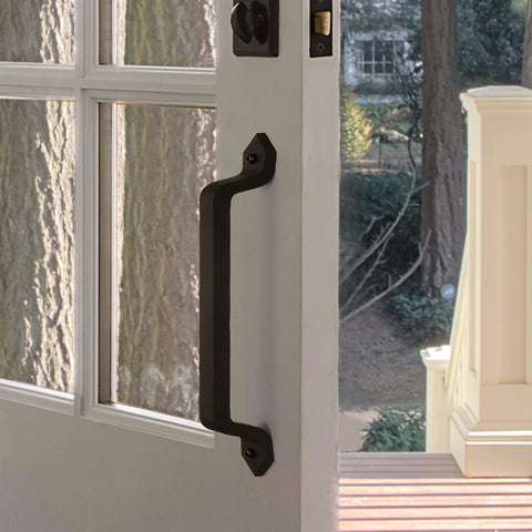 Barn Door Handle Set Eleven And One Eighth Inch Built Tough Rustic Cast Iron Gate Pulls in black on a white outdoor door.