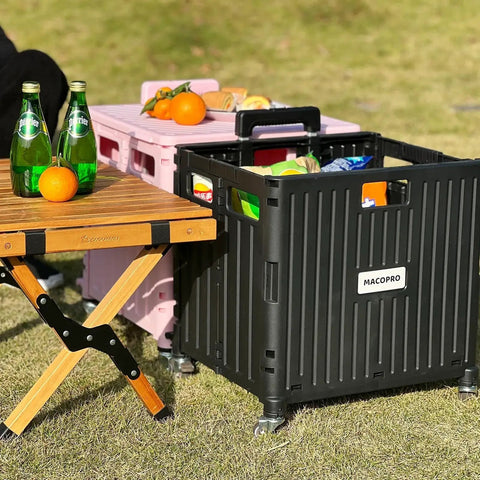 Folding Utility Cart With Lid And Basket On Four 360 Degree Rotating Wheels in use outdoors next to a wooden table with drinks and oranges