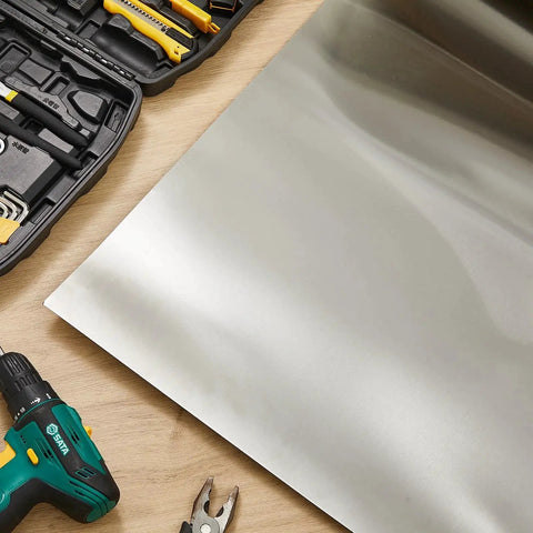 Stainless Steel Sheet 24x96 Inches 24ga Brushed Finish Heavy Duty Boss Grade Metal Plate next to tools on wooden surface