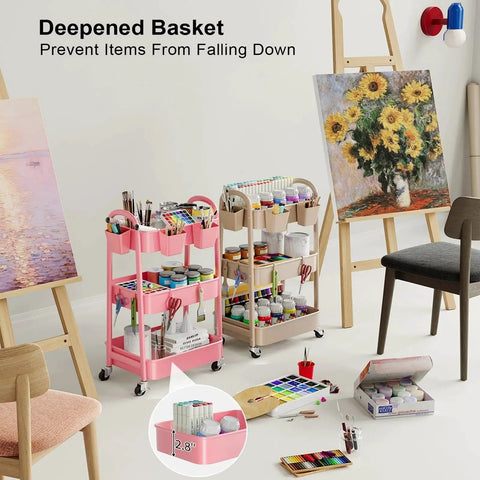 Beige 3 Tier Rolling Cart With Metal On Wheels in art studio, holding paints and supplies, alongside a pink version loaded with brushes.