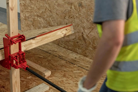 Portable Wall Jack 1000 Lb Capacity For Raising Walls And Beams installed on a 2x4 in a construction setting with worker.