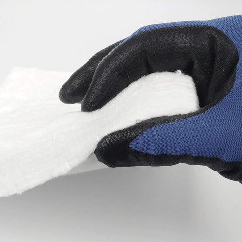 Ceramic fiber insulation blanket, 1 in thick x 16 in x 48 in, white fibrous sheet held by blue and black glove