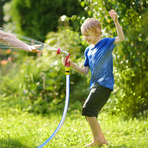 Garden hose 3/4 in x 3 ft, blue flexible hose with red spray nozzle in a sunny yard with a child playing.