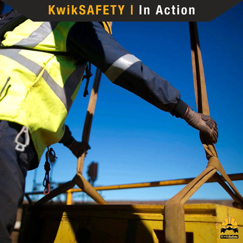 KwikSafety Mighty Sumo 1x8 ft poly web lifting sling in side view, used by worker in hi-vis jacket and gloves.