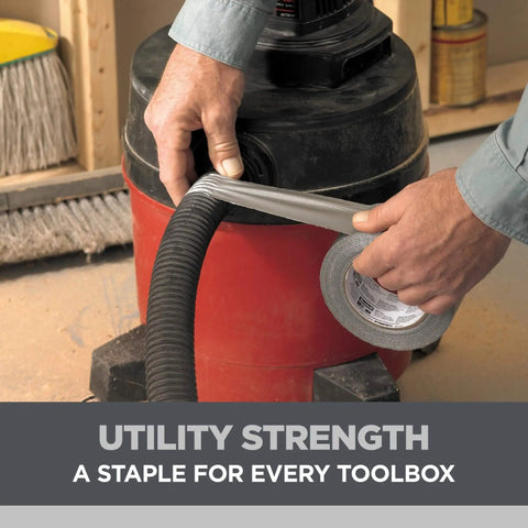 Person using Heavy Duty Duct Tape 1.88 in x 45 yd (2 Rolls) to seal a vacuum hose, demonstrating multi-surface industrial adhesive use.