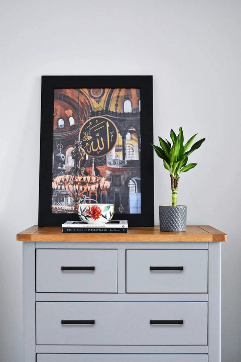 Gray dresser with matte black handles, featuring framed artwork and plant, showcasing set of 30 matte black square cabinet handles 3 3/4 inch center to center.
