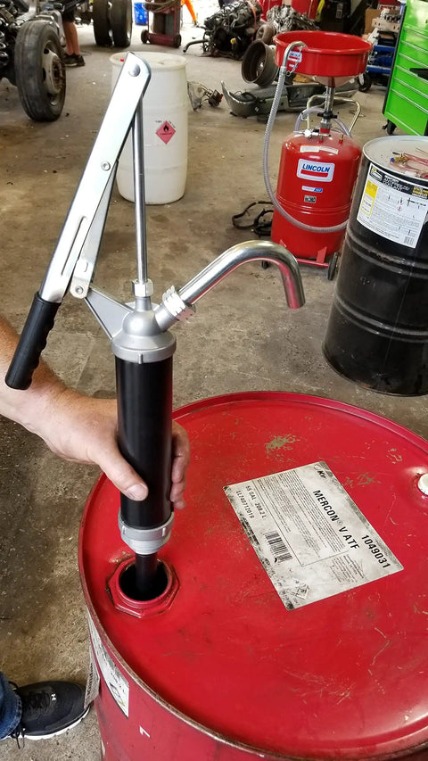 Guardian Lever Action Drum Transfer Pump For 16 To 55 Gallon Drums With 2 Inch Bung And Bushing, 10 Oz Per Stroke in use.