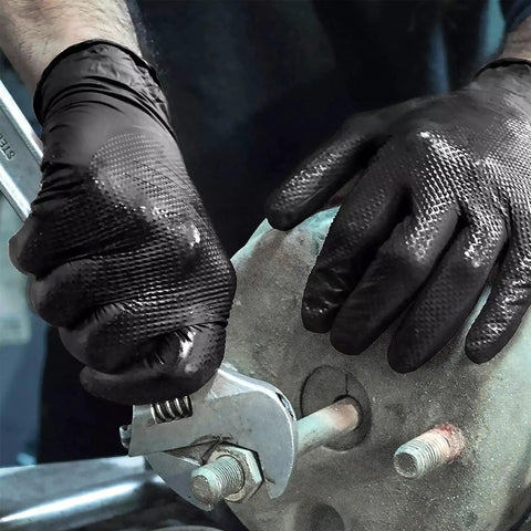 Person wearing Heavy Duty Black Nitrile Gloves 8 Mil Diamond Texture Powder Free Food Safe 1000 using a wrench.