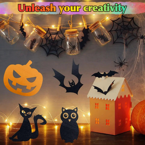 Halloween-themed DIY craft display with paper cutouts of a pumpkin, bat, cat, and owl, illuminated by fairy lights and jars.