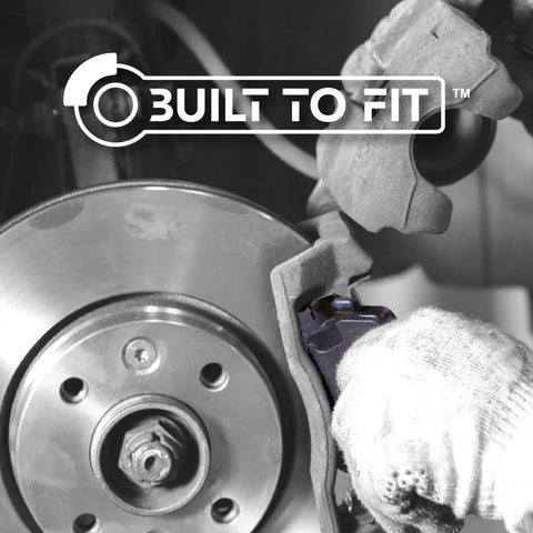 Centric Premium 301.09050 rear ceramic brake pads set on a brake caliper with rotor