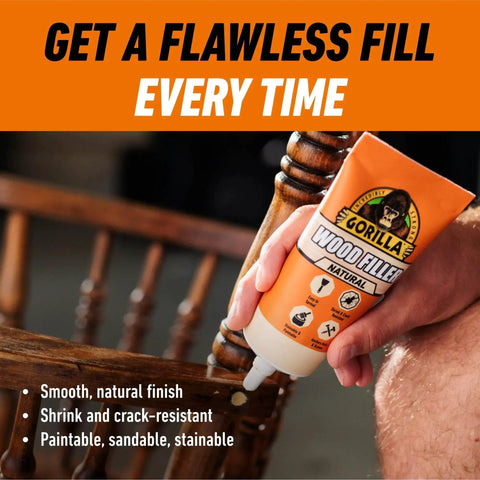 All Purpose Wood Filler Natural Color 6 Ounce Tube Pack Of 1 held by a hand, highlighting smooth table repair, indoors.