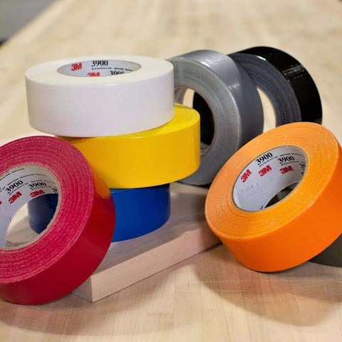 Stack of colorful duct tapes showing Multi-Purpose Duct Tape 3900 Yellow with rubber adhesive, water resistant cloth backing