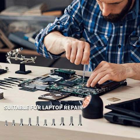 Technician using 500 Pcs Tiny Laptop Screw Set M1.2 M1.4 M2 for computer repairs, carbon steel screws laid out on table, silver finish.