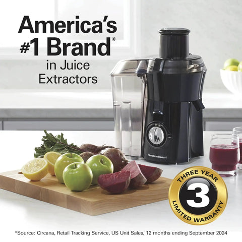 Hamilton Beach juicer machine in black with 3-inch feed chute and large pulp container on a kitchen counter.