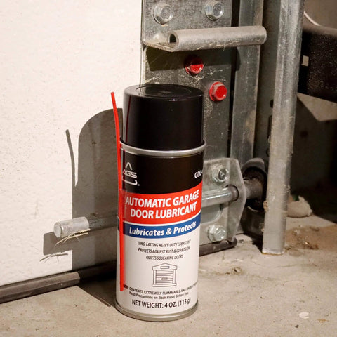 4 oz aerosol can of garage door lubricant spray next to garage track, designed for smooth operation and reducing squeaks.