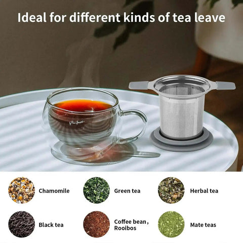 Stainless Steel Loose Leaf Tea Infuser With Extra Fine Mesh Ball Heat Proof Dual Handle Steeper next to a glass cup of tea