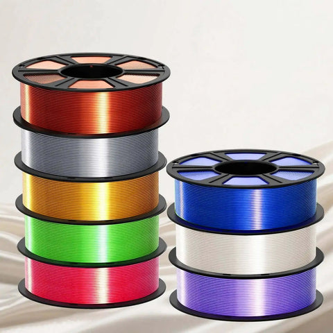 Multiple spools of colorful Silk PLA Filament 1.75mm for 3D printer including metallic white with glossy silk finish.