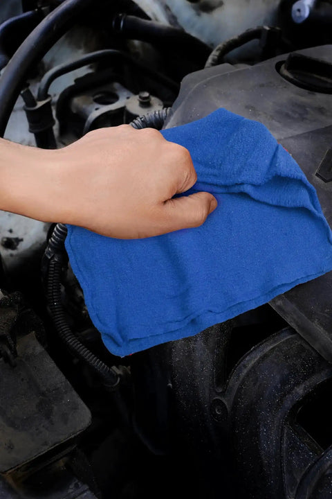 Hand using blue Ultra Absorbent Cotton Shop Towels Pack Of 50 12 By 14 Inches Super Soft Rags for auto care on engine